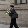 Black All-Day Tote - carried by a man holding flowers