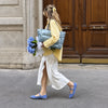 Blue Everyday Puffer — lifestyle photograph with flowers